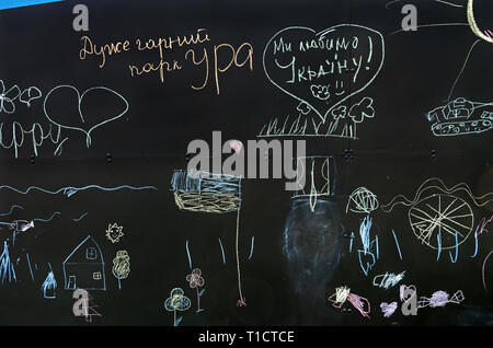 Childish scrawl chalk on a blackboard in the inclusive gaming park of the city. The inscription reads - a very good park, cheers and we love Ukraine Stock Photo