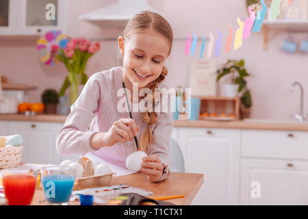 Cheerful blonde girl turning on her imagination Stock Photo