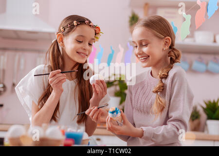 Amazing longhaired teenagers having fun during painting Stock Photo