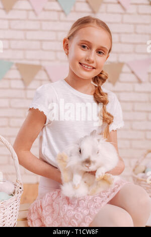 Portrait of charming girl that holding rabbit Stock Photo