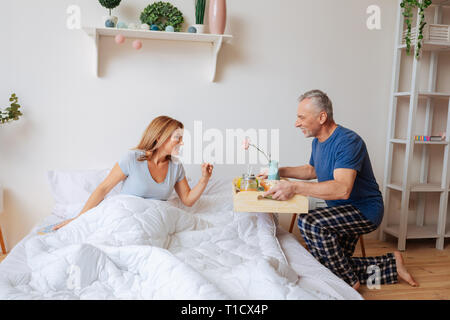 Husband making surprise bringing breakfast in the morning Stock Photo