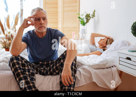 Dark-eyed mature man feeling bad after quarrel with his wife