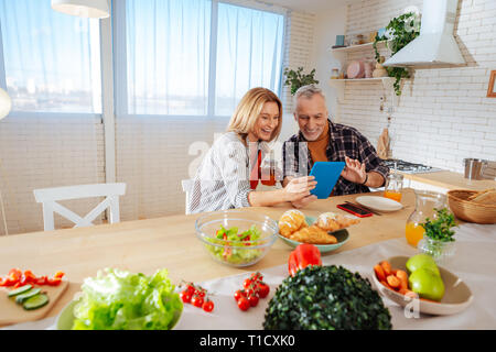 Mother and father having video chat with daughter in the morning Stock Photo