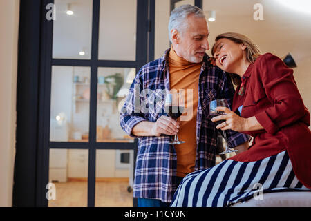 Cheerful laughing wife leaning on shoulder of her husband Stock Photo