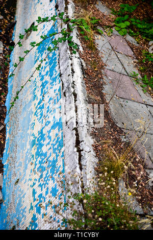 Broken blue azure  retro tiles mosaic in abandoned pool - Berengaria Hotel, Cyprus Stock Photo