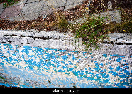 Broken blue azure  retro tiles mosaic in abandoned pool - Berengaria Hotel, Cyprus Stock Photo