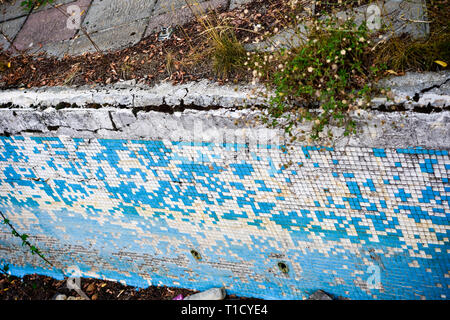 Broken blue azure  retro tiles mosaic in abandoned pool - Berengaria Hotel, Cyprus Stock Photo
