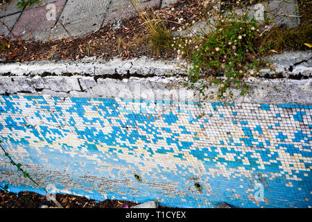 Broken blue azure  retro tiles mosaic in abandoned pool - Berengaria Hotel, Cyprus Stock Photo