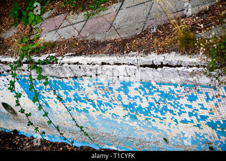 Broken blue azure  retro tiles mosaic in abandoned pool - Berengaria Hotel, Cyprus Stock Photo