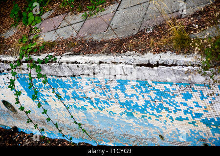Broken blue azure  retro tiles mosaic in abandoned pool - Berengaria Hotel, Cyprus Stock Photo