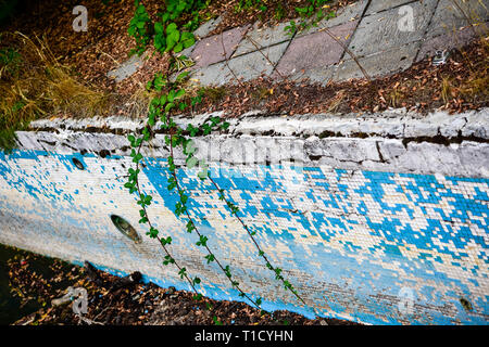 Broken blue azure  retro tiles mosaic in abandoned pool - Berengaria Hotel, Cyprus Stock Photo