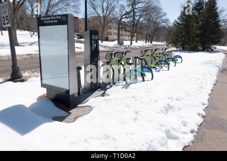 Bicycle rentals in April snow along the Mississippi River Boulevard path. St Paul Minnesota MN USA Stock Photo