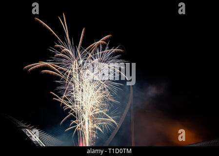 Colorful fireworks over the night city, free black space for text. Stock Photo
