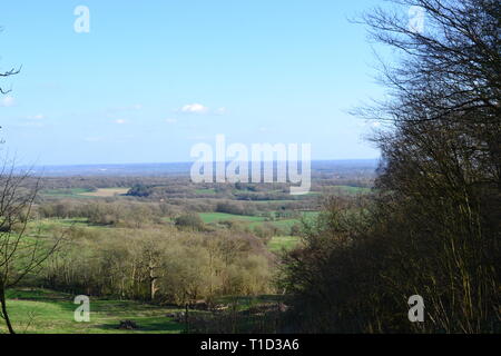 View from the Octavia Hill seat, Ide Hill National Trust Woods, Kent, England in early spring looking south east across the low weald of Kent Stock Photo