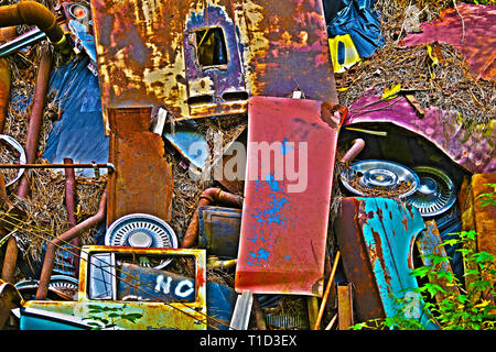 A Pile of Scrap Metal with Various Car Parts and Other Items at a Junk Yard Stock Photo