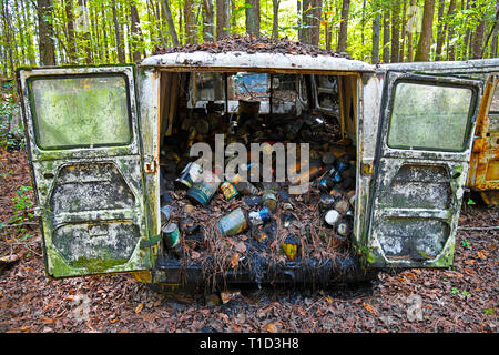 White, GA / USA - October27, 2018 - Image of the Back of a Scrap Van in a Junk Yard that is full of Old Oil Cans Stock Photo
