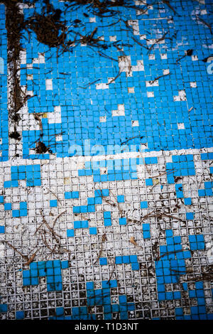 Broken blue azure  retro tiles mosaic in abandoned pool - Berengaria Hotel, Cyprus Stock Photo