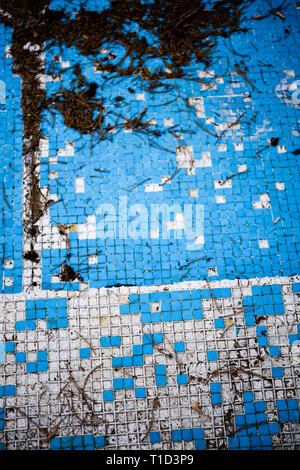 Broken blue azure  retro tiles mosaic in abandoned pool - Berengaria Hotel, Cyprus Stock Photo