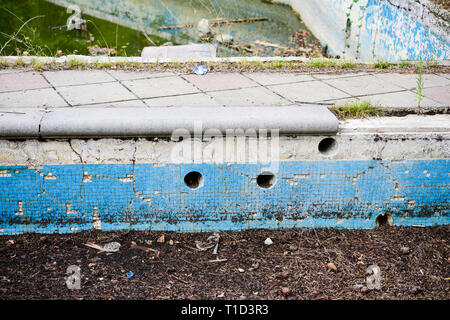 Broken blue azure  retro tiles mosaic in abandoned pool - Berengaria Hotel, Cyprus Stock Photo