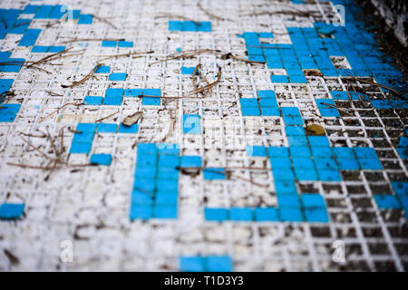 Broken blue azure  retro tiles mosaic in abandoned pool - Berengaria Hotel, Cyprus Stock Photo