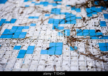 Broken blue azure  retro tiles mosaic in abandoned pool - Berengaria Hotel, Cyprus Stock Photo