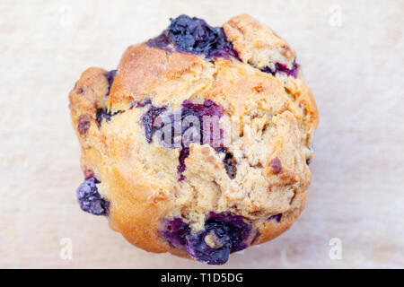 Homemade vegan blueberry muffin presented on a wooden plate Stock Photo