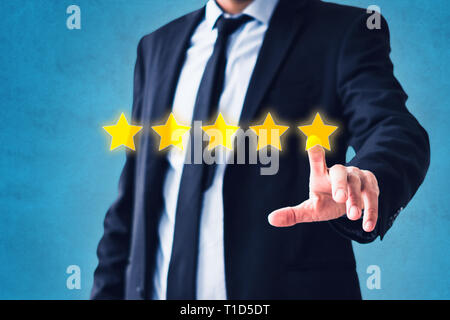 person pointing on 5 star review, costumer feedback concept - five stars rating Stock Photo