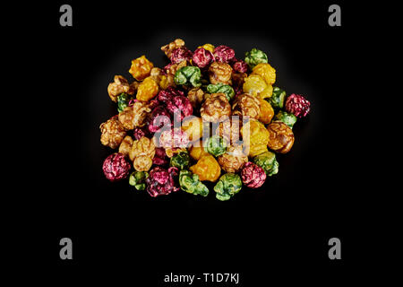 multicolored caramel popcorn on a black background. Stock Photo