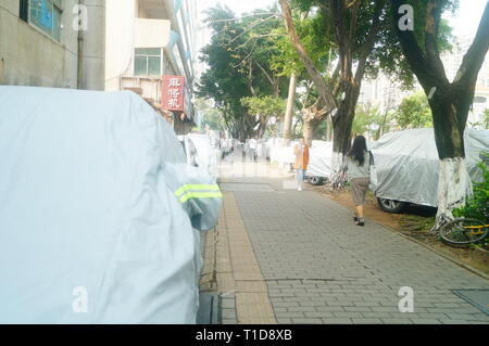 Shenzhen, China: Many cars parked on the side of the sidewalk Stock Photo