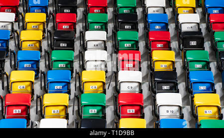 Rows of an empty colourful plastic seats Stock Photo