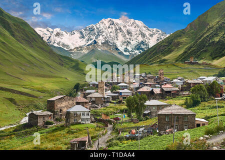 Stone medieval Svaneti tower houses of Chvibiani with mount Shkhara (5193m) behind, Ushguli, Upper Svaneti, Samegrelo-Zemo Svaneti, Mestia, Georgia.   Stock Photo