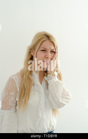 Teeth Problem. Woman is feeling Tooth Pain. Closeup Of Beautiful Sad Girl Suffering From Strong Tooth Pain. Attractive Female Feeling Painful Toothach Stock Photo