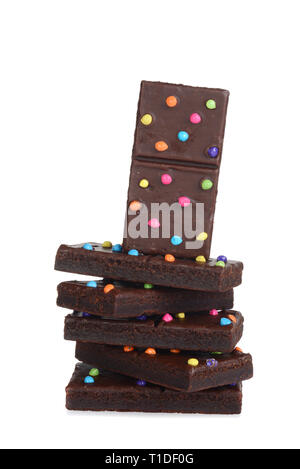 pile of chocolate fudge brownies with candy pieces on white Stock Photo