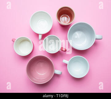 Coffee cups in pink. Empty coffee cups white and pink color against pink background, top view Stock Photo