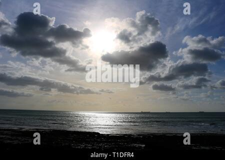 Sun going down on the ocean Stock Photo