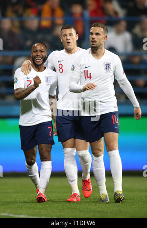 England's Raheem Sterling (left) celebrates his side's fourth goal of the game, scored by Harry Kane (not pictured) with Ross Barkley, and Jordon Henderson during the UEFA Euro 2020 Qualifying, Group A match at the Podgorica City Stadium. Stock Photo