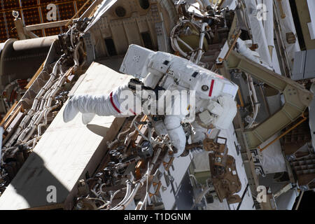 Expedition 59 NASA astronaut Anne McClain works on the power supply during a spacewalk outside the International Space Station March 22, 2019 in Earth Orbit. Astronauts McClain and Hague spent six-hours and 39-minutes outside the space station to upgrade the orbital complex's power storage capacity. Stock Photo