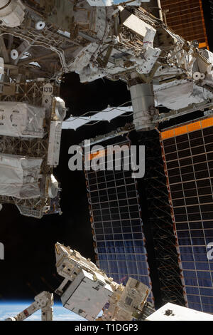 Expedition 59 NASA astronaut Anne McClain, top, works on the power system during a spacewalk outside the International Space Station March 22, 2019 in Earth Orbit. Astronauts McClain and Hague spent six-hours and 39-minutes outside the space station to upgrade the orbital complex's power storage capacity. Stock Photo