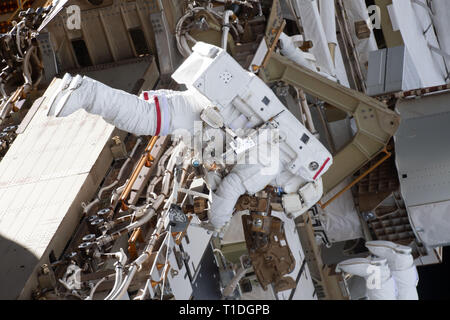 Expedition 59 NASA astronaut Anne McClain works on the power supply during a spacewalk outside the International Space Station March 22, 2019 in Earth Orbit. Astronauts McClain and Hague spent six-hours and 39-minutes outside the space station to upgrade the orbital complex's power storage capacity. Stock Photo