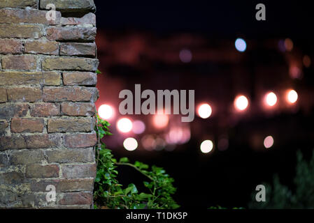 Brick red wall and bokeh from the street by night Stock Photo