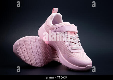 Unbranded pink running shoes on a black background Stock Photo