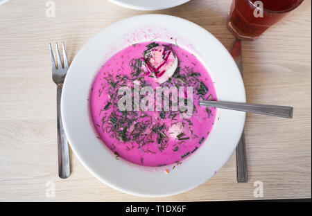 A bowl of Polish chlodnik, a delicious cold soup made with beetroot, sour cream, hard boiled egg, and fresh herbs, served at Bar Bambino, a milk bar. Stock Photo
