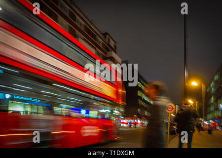 Blurred image taken at night of one of the late night last London buses on route through the city centre Stock Photo