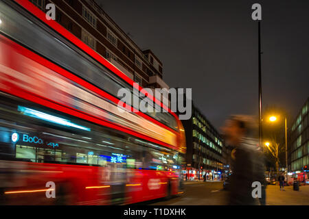 Blurred image taken at night of one of the late night last London buses on route through the city centre Stock Photo