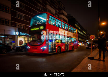 Blurred image taken at night of one of the late night last London buses on route through the city centre Stock Photo