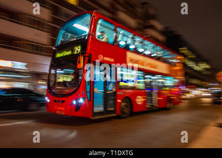 Blurred image taken at night of one of the late night last London buses on route through the city centre Stock Photo