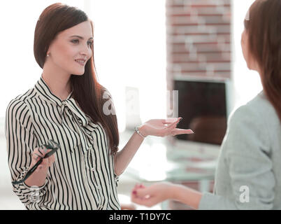 two young employees are talking in the office. Stock Photo