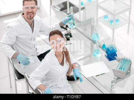 two positive scientists are working in the laboratory. Stock Photo