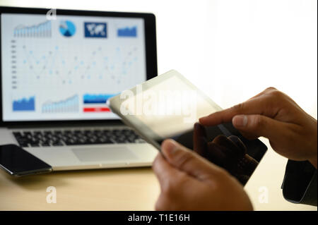 man  hands multitasking man using tablet close up close up working in office Stock Photo