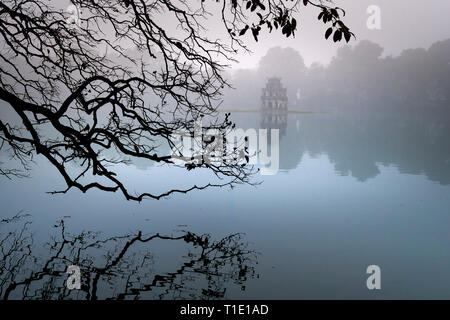 Hoan Kiem Lake ( Ho Guom) in the center of Hanoi in the fog in the morning. Hoan Kiem Lake is a famous tourist place in Hanoi Stock Photo